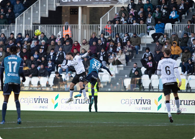 Soccer players on a field with one player in the air. Contenido generado con IA