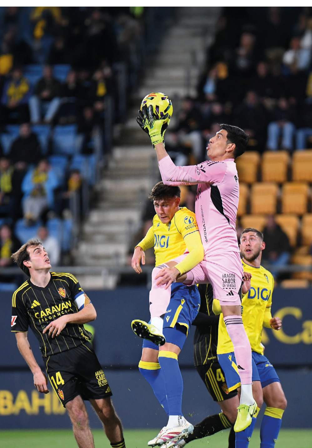 Soccer players on a field with one player jumping in the air to kick the ball. Contenido generado con IA