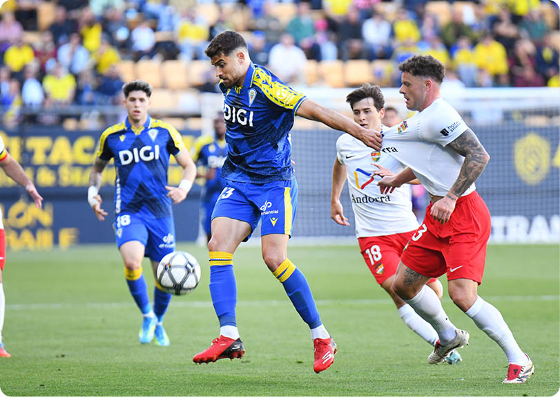 A soccer player in a blue uniform is kicking a soccer ball. Descripci n generada con IA