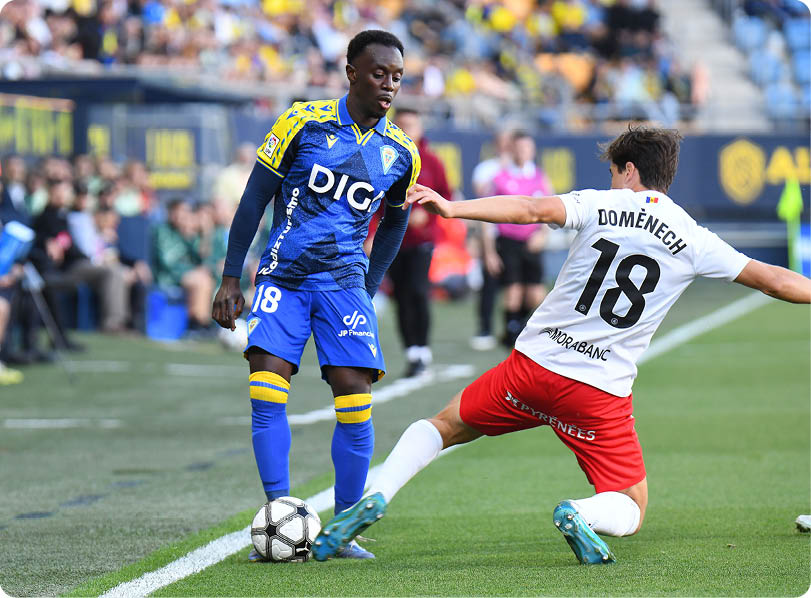 Two soccer players on a field. Descripci n generada con IA