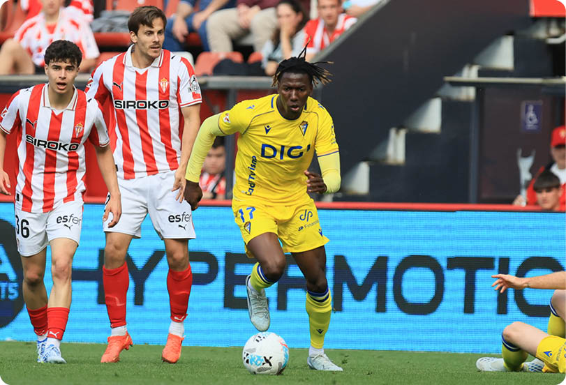 A soccer player in a yellow shirt is about to kick the ball. Descripci n generada con IA