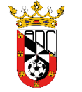 A heraldic shield divided diagonally with black and white checkered pattern on one side and red with yellow castle symbols on the other, topped with a gold crown adorned with jewels and floral decorations. Descripci n generada con IA